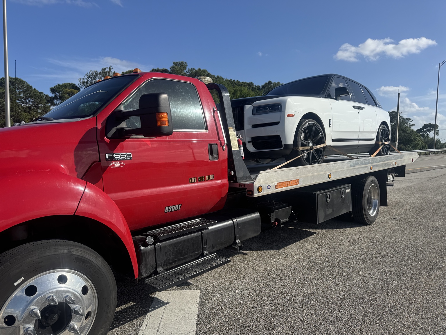 Flatbed towing luxury car